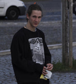 Man wearing the black Shredding Rat Crewneck sweatshirt in the street