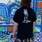 Back print of the black Champ Graphic Tee against a mural