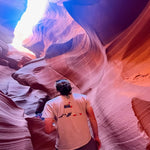 Man in the sand Champ Graphic Tee walking through a red canyon